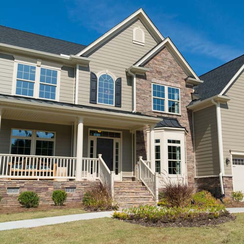 White siding house on a grassy hill
