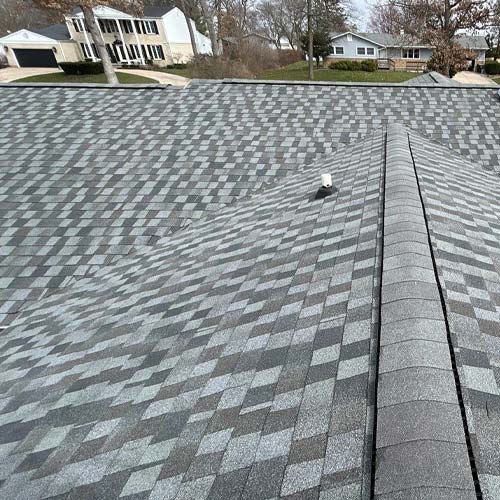 Roof on brown house with flags